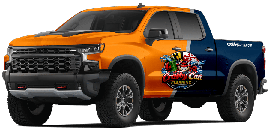 An orange and blue pickup truck with Crabby Can Cleaning logo and graphics on the side, parked in a neutral background.